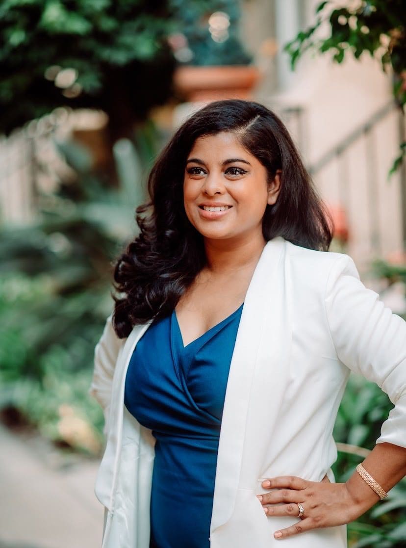 Nadia Ramsaran looking Positive And Professional Woman In White Jacket Posing For Portrait
