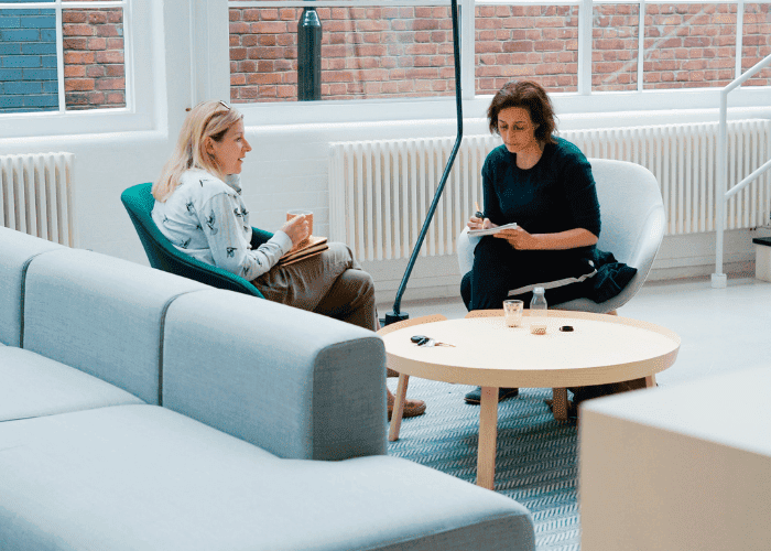 Woman And Man Discussing In A Modern Office Space