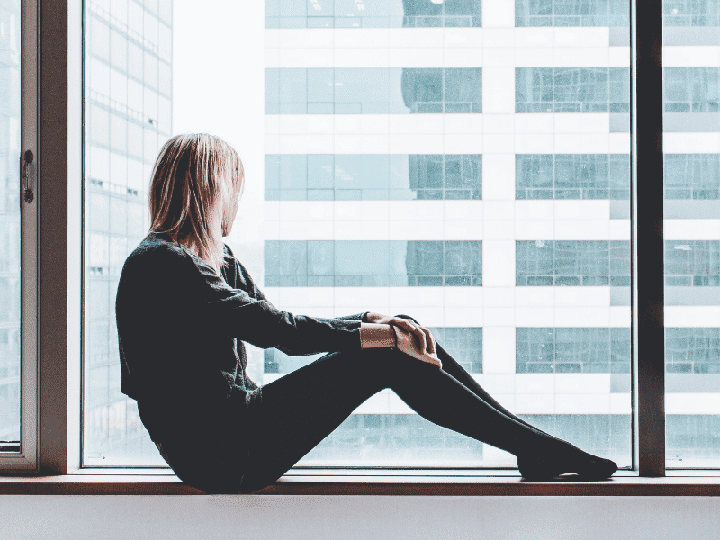 Woman Perusing City View From High Floor