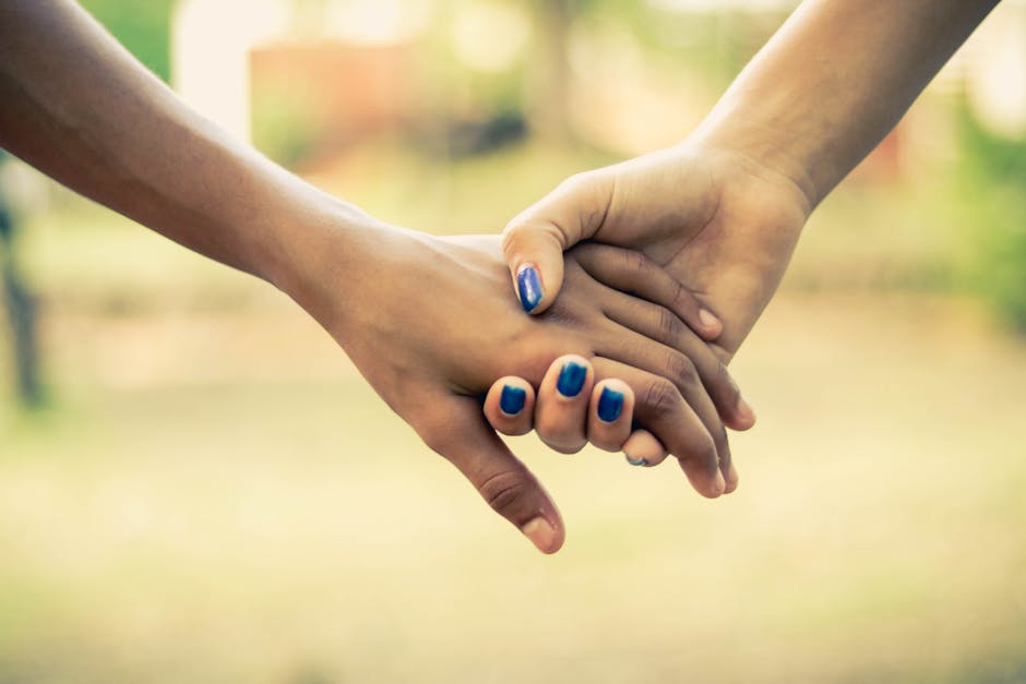 A close-up image of two people holding hands, conveying unity and support.